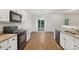 Open kitchen with sliding glass doors and black appliances, creating a modern feel at 1835 Allegheny Dr, Gastonia, NC 28054