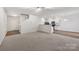 Open-concept living room with a neutral color palette, a view of the kitchen, and carpet flooring at 1835 Allegheny Dr, Gastonia, NC 28054