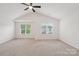 Open main bedroom with vaulted ceiling, ceiling fan, and two large windows at 1835 Allegheny Dr, Gastonia, NC 28054