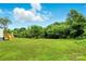 Expansive grassy backyard view with trees at 2002 Kingston Rd, Kingstown, NC 28150