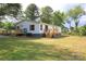Back of the house with a deck and ramp in a large backyard at 2002 Kingston Rd, Kingstown, NC 28150