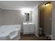 Bathroom features a soaking tub, tile surround and modern vanity at 2002 Kingston Rd, Kingstown, NC 28150