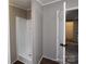 A bathroom highlighting a shower and next to an opening into the closet at 2002 Kingston Rd, Kingstown, NC 28150