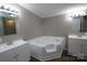 Bathroom features a soaking tub, tile surround and double sink at 2002 Kingston Rd, Kingstown, NC 28150