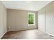 View of the bedroom with beautiful wood-look flooring and natural light from the window at 2002 Kingston Rd, Kingstown, NC 28150