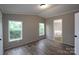 Bedroom with light colored walls, wood laminate floors, and natural light at 2002 Kingston Rd, Kingstown, NC 28150
