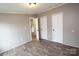 Bedroom with wood-look floors, neutral wall paint, and two white doors for closet space at 2002 Kingston Rd, Kingstown, NC 28150
