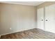 Bedroom with wood-look flooring and doors for entry and closet access at 2002 Kingston Rd, Kingstown, NC 28150