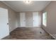 Bedroom with light colored walls, wood laminate floors, and white doors at 2002 Kingston Rd, Kingstown, NC 28150