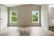 This bedroom features wood floors, two windows, and a spacious layout at 2002 Kingston Rd, Kingstown, NC 28150
