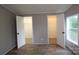 Bedroom with light colored walls, wood laminate floors, and closet at 2002 Kingston Rd, Kingstown, NC 28150