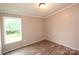 Bedroom with wood laminate floors, natural light, and light-colored walls at 2002 Kingston Rd, Kingstown, NC 28150