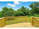 Wooden backyard deck, with railings, overlooking lush green lawn and trees at 2002 Kingston Rd, Kingstown, NC 28150
