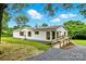 Charming single-story home with white siding, red shutters and a convenient accessibility ramp at 2002 Kingston Rd, Kingstown, NC 28150