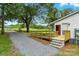 Exterior home view with deck, ramp, gravel driveway, and verdant yard at 2002 Kingston Rd, Kingstown, NC 28150