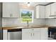This kitchen features wooden countertops, white cabinets, and modern stainless appliances at 2002 Kingston Rd, Kingstown, NC 28150