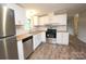 Modern kitchen featuring stainless steel appliances, white cabinetry, and butcher block countertops at 2002 Kingston Rd, Kingstown, NC 28150