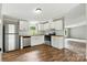 Modern kitchen with white cabinets, stainless appliances, and wood countertops at 2002 Kingston Rd, Kingstown, NC 28150