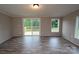 Bright living room features neutral paint, modern vinyl flooring, and a sliding glass door to the deck at 2002 Kingston Rd, Kingstown, NC 28150