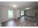 An open-concept living room features neutral paint, modern vinyl flooring, and plenty of natural light at 2002 Kingston Rd, Kingstown, NC 28150