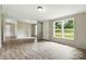 Spacious living room with neutral walls, wood-look floors, and large windows at 2002 Kingston Rd, Kingstown, NC 28150