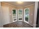 Bright sunroom features three large windows with views of the outdoors at 2002 Kingston Rd, Kingstown, NC 28150