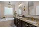 Luxurious bathroom with double vanity, granite countertops, and a soaking tub at 2007 Bishops Ct, Cornelius, NC 28031