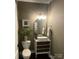 Stylish powder room with decorative vanity, mirror, and light fixtures at 2007 Bishops Ct, Cornelius, NC 28031