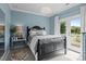 Chic bedroom with elegant chandelier, mirrored side table, and access to a private balcony at 2007 Bishops Ct, Cornelius, NC 28031
