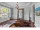 Formal dining room featuring a chandelier, large windows, and elegant decor at 2007 Bishops Ct, Cornelius, NC 28031
