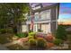 Charming two-story home featuring a balcony, well-kept garden, and an inviting facade at sunset at 2007 Bishops Ct, Cornelius, NC 28031