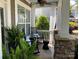 Cozy front porch with rocking chairs, sheer curtains, and stylish decor, perfect for relaxing outdoors at 2007 Bishops Ct, Cornelius, NC 28031