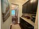 Hallway view of the dining room, with black cabinets and granite countertop at 2007 Bishops Ct, Cornelius, NC 28031
