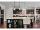 Modern kitchen with an island, granite counters, stainless steel appliances, and dark wood cabinets at 2007 Bishops Ct, Cornelius, NC 28031