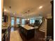 Open-concept kitchen featuring a large island, stainless steel appliances, and seamless flow to the living area at 2007 Bishops Ct, Cornelius, NC 28031
