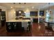 Modern kitchen with dark cabinetry, a granite island with seating, and a breakfast nook area at 2007 Bishops Ct, Cornelius, NC 28031
