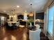 Well-lit kitchen boasts a large island with seating, stainless steel appliances, and dark wood cabinetry at 2007 Bishops Ct, Cornelius, NC 28031