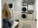 Well-organized laundry room with a stacked washer and dryer and built-in storage cabinets at 2007 Bishops Ct, Cornelius, NC 28031