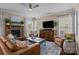 Spacious living room with a stone fireplace, large windows, and hardwood floors at 2007 Bishops Ct, Cornelius, NC 28031
