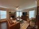 Comfortable living room featuring a stone fireplace, hardwood floors, and a large television at 2007 Bishops Ct, Cornelius, NC 28031