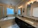 Relaxing main bathroom includes a soaking tub, double vanity, and ample storage at 2007 Bishops Ct, Cornelius, NC 28031