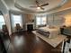 Spacious main bedroom features hardwood floors, fireplace, and decorative trey ceiling at 2007 Bishops Ct, Cornelius, NC 28031
