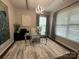 Bright office with a modern glass desk, stylish light fixture, and a large window, ideal for productivity at 2007 Bishops Ct, Cornelius, NC 28031