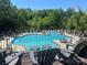 Beautiful community pool surrounded by lush greenery and ample seating, perfect for relaxation and recreation at 2007 Bishops Ct, Cornelius, NC 28031