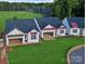 Aerial view of new home construction showcasing rooflines and garage access in a green neighborhood at 2085 Bonds Ln # 26, Fort Mill, SC 29715