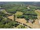 Aerial shot of the property showcasing the house, land, and surrounding greenery at 21121 Shearer Rd, Davidson, NC 28036