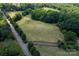 A sprawling, cultivated field bordered by lush trees offers a tranquil and expansive vista at 21121 Shearer Rd, Davidson, NC 28036