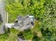 Aerial view of a beautiful home with a private backyard, pool and deck surrounded by lush trees at 2213 Normandin Ct, Charlotte, NC 28216