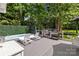 Outdoor deck with swim spa, lounge chairs, grill and privacy screen surrounded by trees at 2213 Normandin Ct, Charlotte, NC 28216