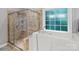 Bathroom featuring tiled walk-in shower and walk-in tub with a large window offering natural light at 2213 Normandin Ct, Charlotte, NC 28216